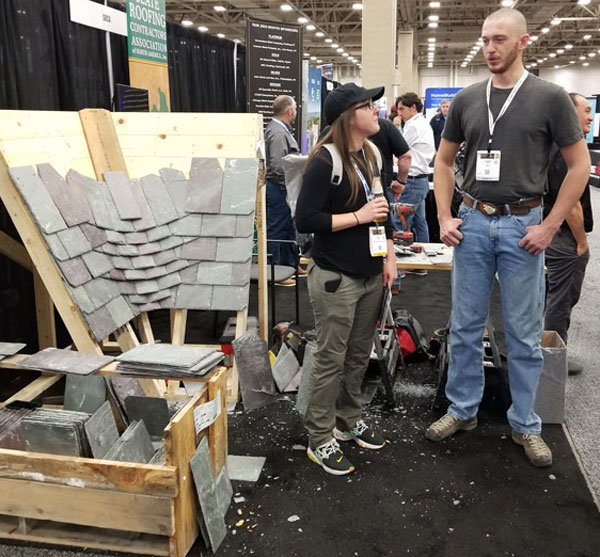 Dominic Nave of Jenkins Slate Masters Inc. demonstrates a woven slate valley. Dominic Nave of Jenkins Slate Masters Inc. demonstrates a woven slate valley at the SRCA booth at the 2023 IRE in Dallas, Texas